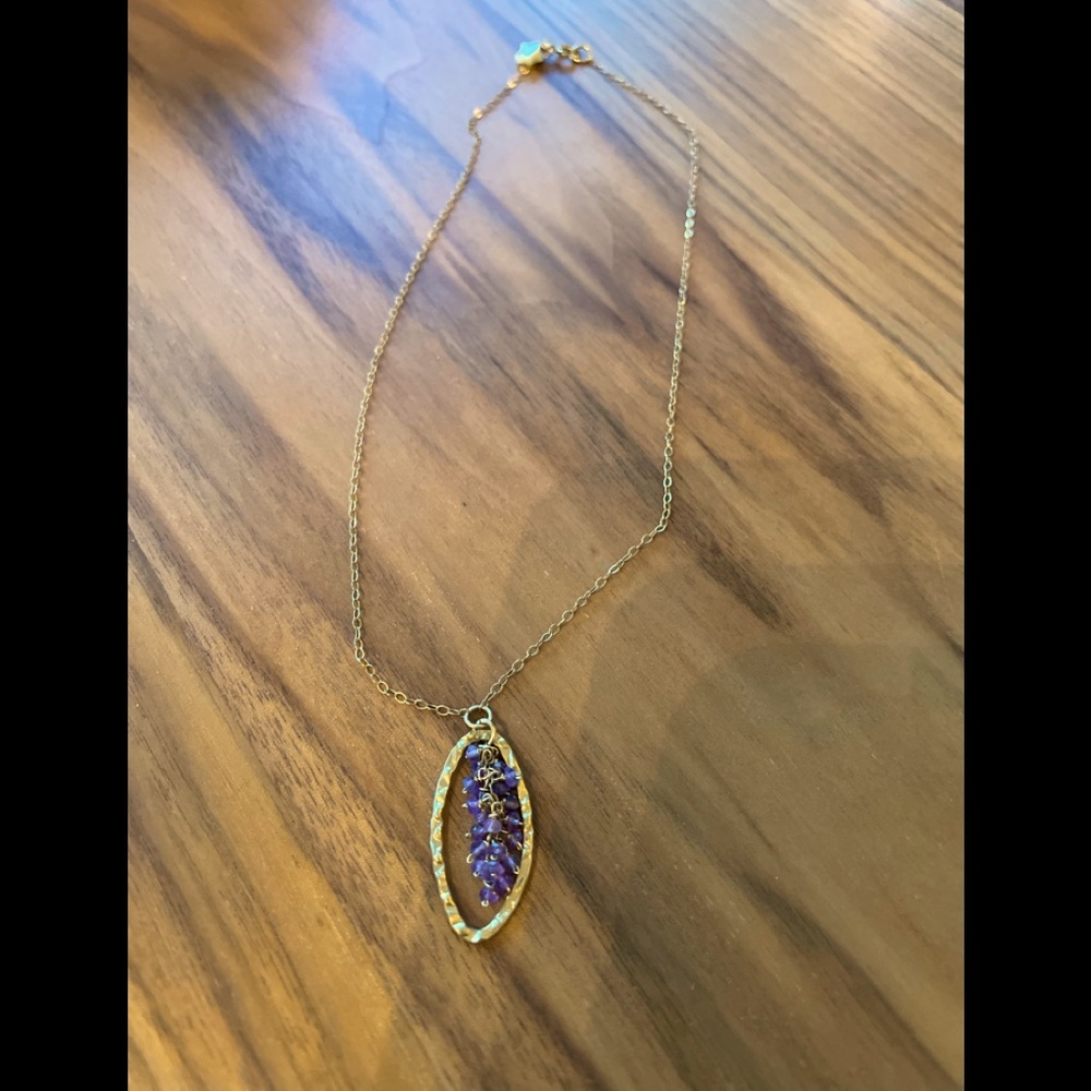 Delicate gold necklace with purple beads